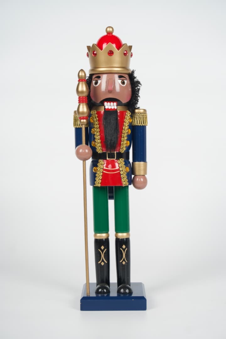 Walnut King African American nutcracker with gold crown, curly hair, and beard in a blue and red coat