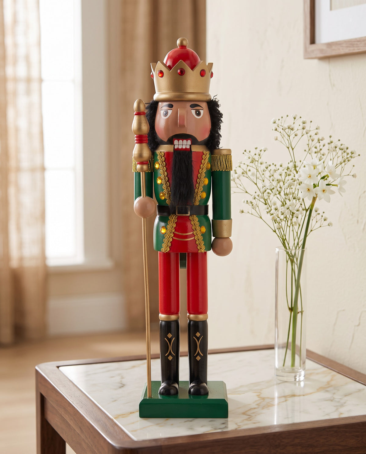 Maple King brown-skin nutcracker with gold crown on a marble side table