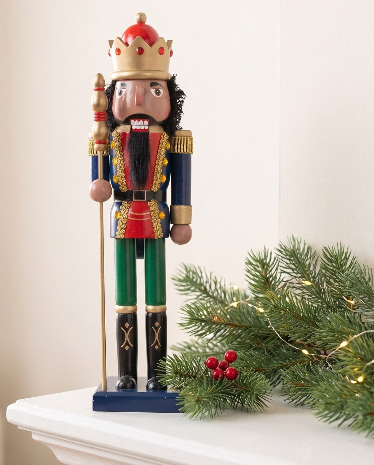 Walnut King Black nutcracker with gold crown and curly hair displayed on a decorated holiday mantel